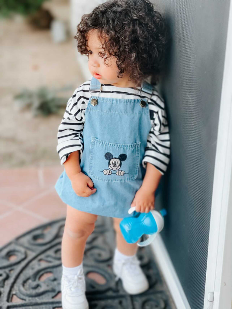 Baby boy wearing a mickey mouse bubble romper overalls